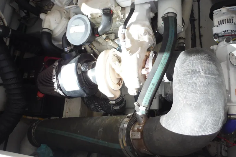 Slide: The Image of Engine compartment of a 2007 Tiara Yachts 3600 Open, showcasing mechanical components and hoses. - 49