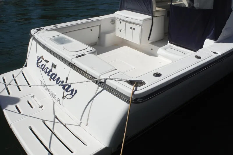 Slide: The Image of 2007 Tiara Yachts 3600 Open boat docked, featuring spacious deck and storage compartments. - 56