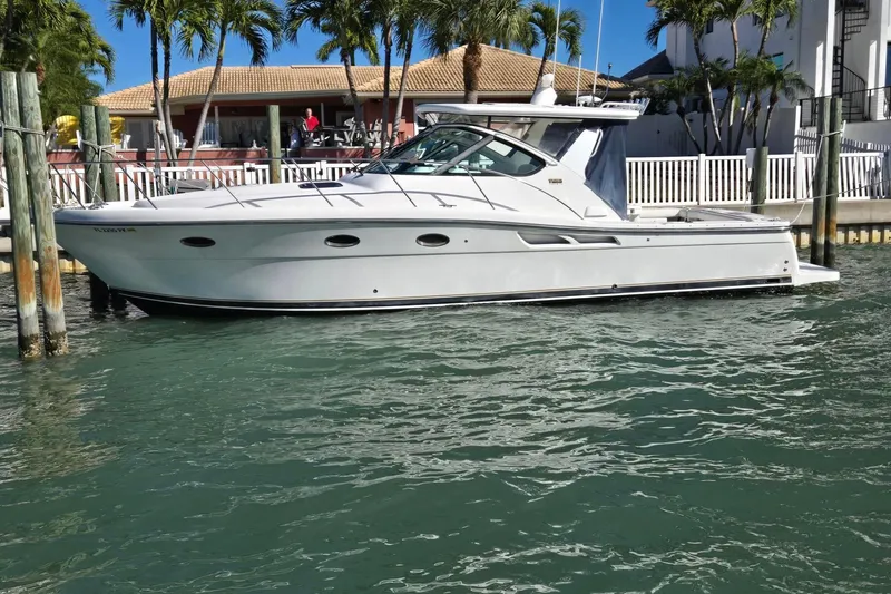 Slide: The Image of 2007 Tiara Yachts 3600 Open docked near waterfront homes and palm trees. - 63