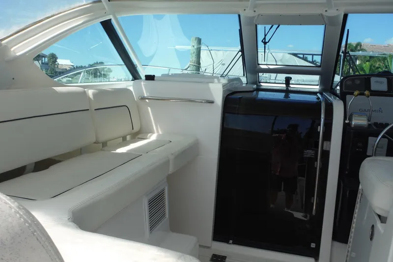 Slide: The Image of 2007 Tiara Yachts 3600 Open interior with white seating and modern controls. - 7