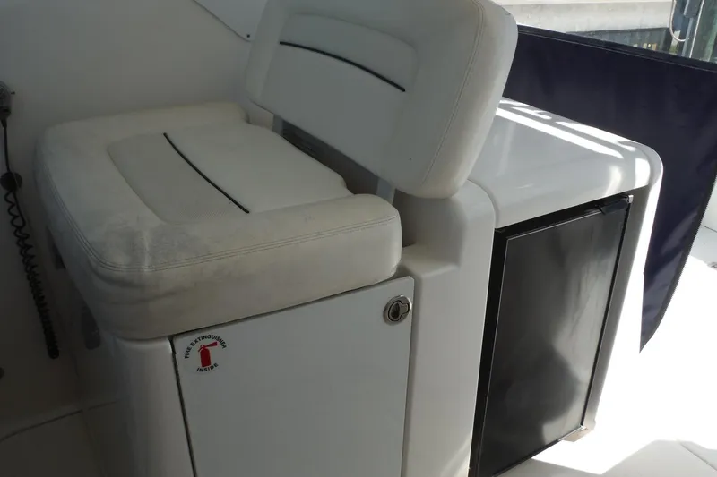 Slide: The Image of 2007 Tiara Yachts 3600 Open interior with white seating and storage compartment. - 9