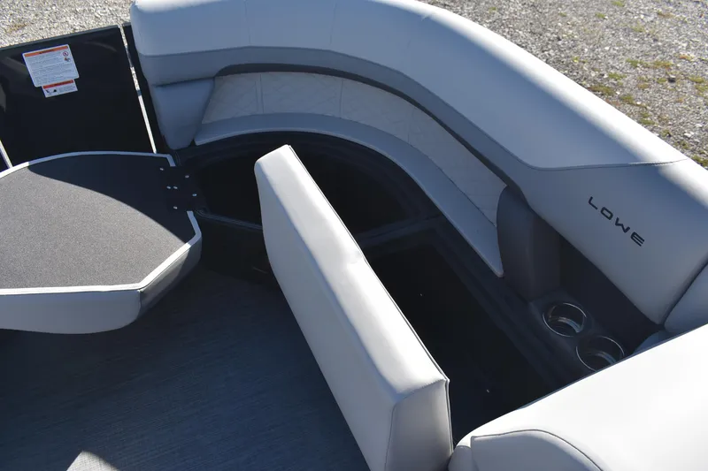 Slide: The Image of 2026 Lowe SS 230 WV boat interior with open storage compartments and cup holders. - 10