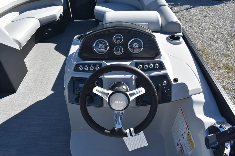 Slide: The Image of 2026 Lowe SS 230 WV boat dashboard with steering wheel and gauges. - 16