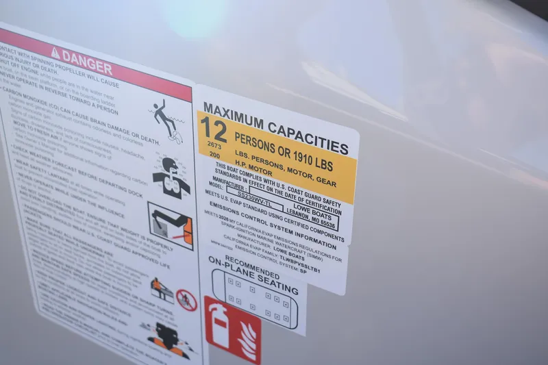 Slide: The Image of Safety label on 2026 Lowe SS 230 WV boat, indicating maximum capacity of 12 persons or 1910 lbs. - 17