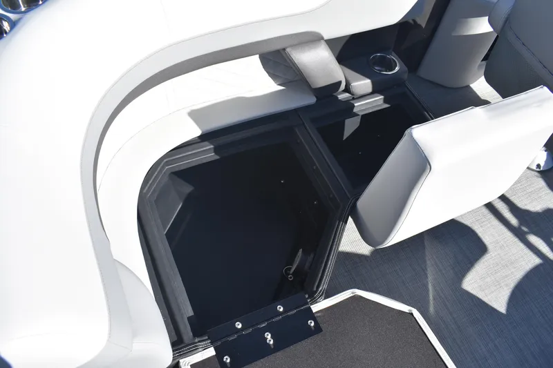 Slide: The Image of 2026 Lowe SS 230 WV boat interior storage compartment with open seat and cup holder. - 22