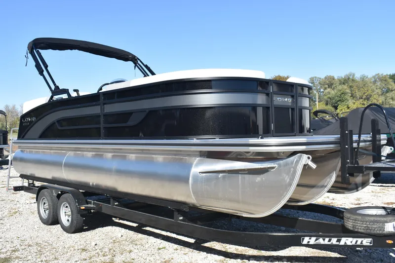 Slide: The Image of 2026 Lowe SS 230 WV pontoon boat on HaulRite trailer, parked outdoors. - 3