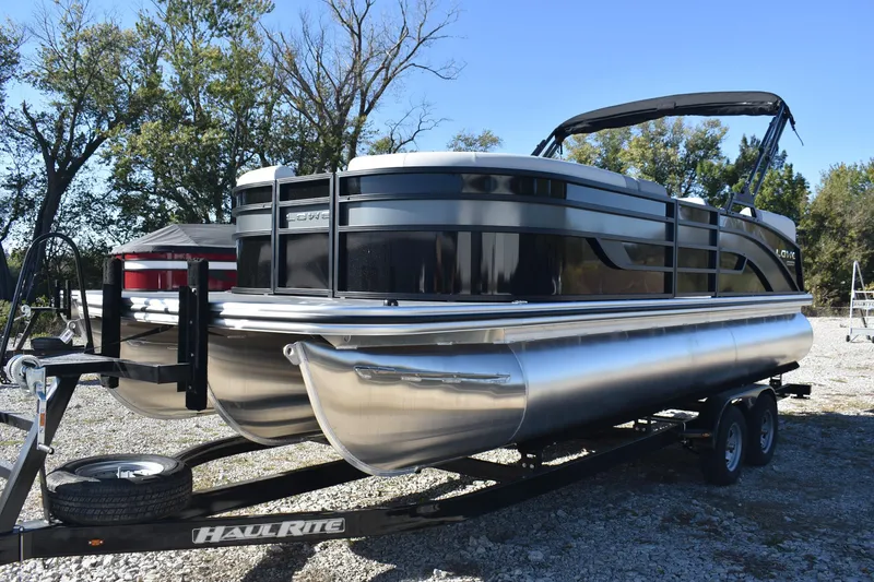 Slide: The Image of 2026 Lowe SS 230 WV pontoon boat on trailer, parked outdoors. - 4