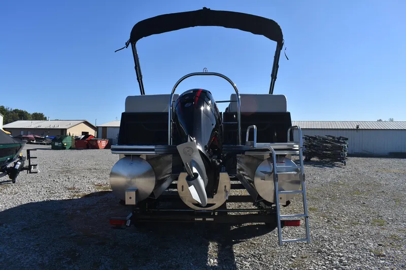 Slide: The Image of 2026 Lowe SS 230 WV pontoon boat with outboard motor and ladder, parked outdoors. - 5