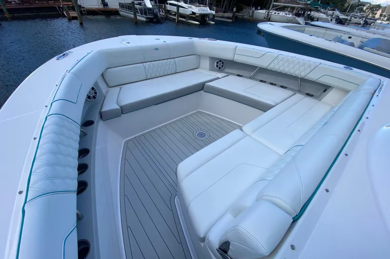 Slide: The Image of Luxurious seating area on a 2021 Regal 38 SAV boat, docked by the water. - 15