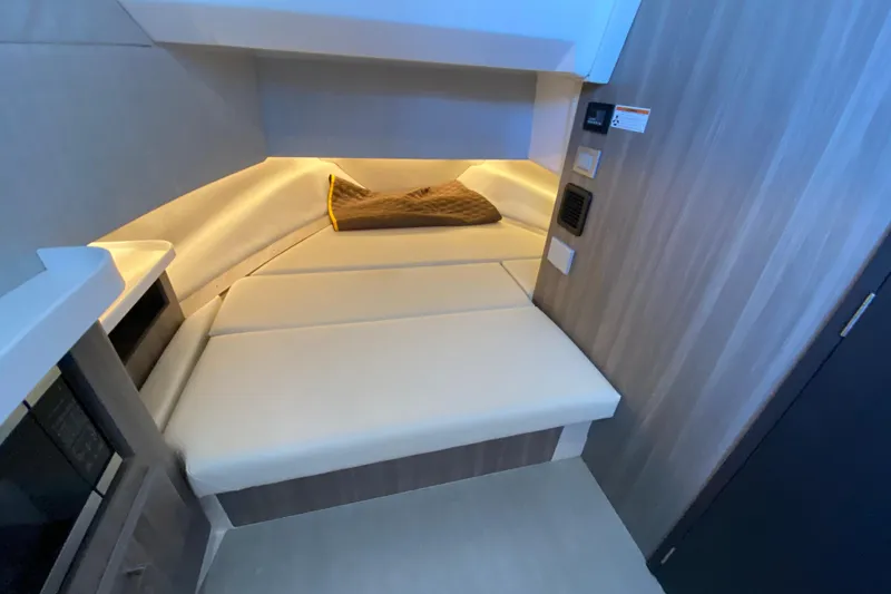 Slide: The Image of 2021 Regal 38 SAV interior cabin with cushioned seating and ambient lighting. - 22