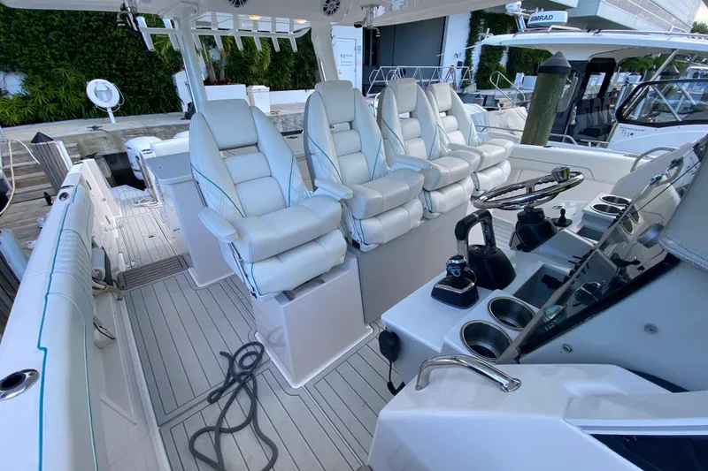 Slide: The Image of 2021 Regal 38 SAV boat interior with luxurious white seating and modern controls. - 26