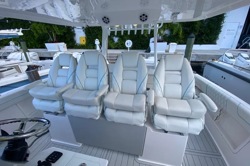 Slide: The Image of Luxurious seating on 2021 Regal 38 SAV boat, featuring four plush captain's chairs. - 31