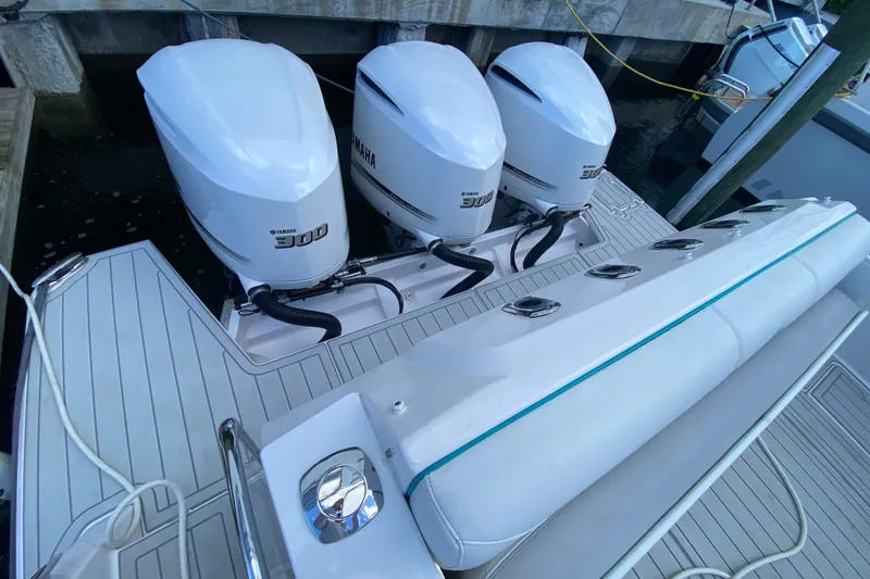Slide: The Image of 2021 Regal 38 SAV boat with triple Yamaha 300 engines, docked at marina. - 37