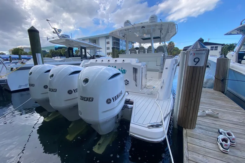 Slide: The Image of 2021 Regal 38 SAV boat docked with Yamaha engines at marina. - 39