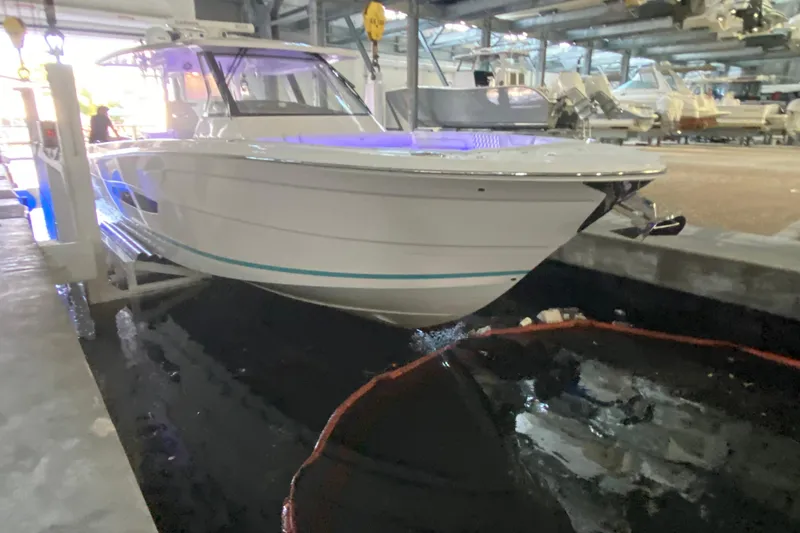 Slide: The Image of 2021 Regal 38 SAV boat docked indoors with blue lighting. - 4