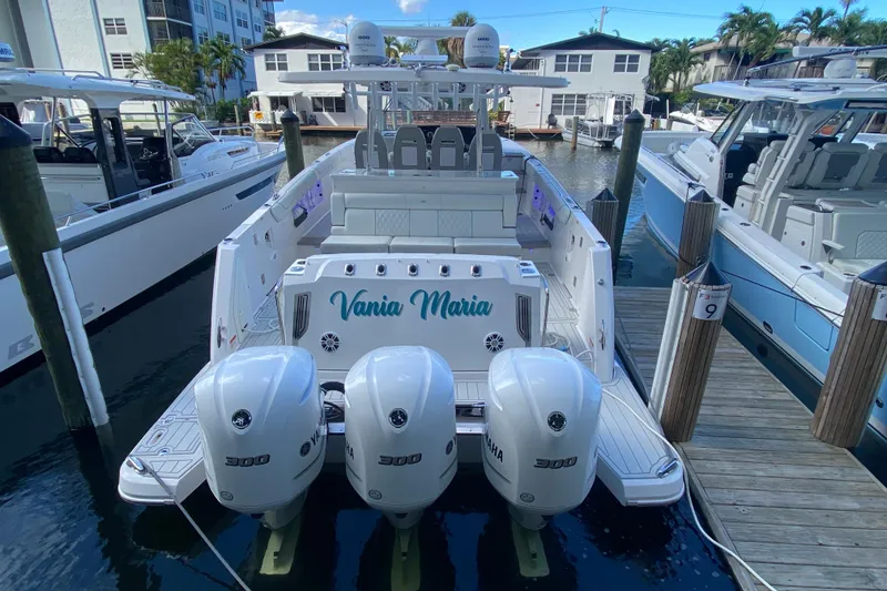 Slide: The Image of 2021 Regal 38 SAV boat docked with triple Yamaha 300 engines. - 42