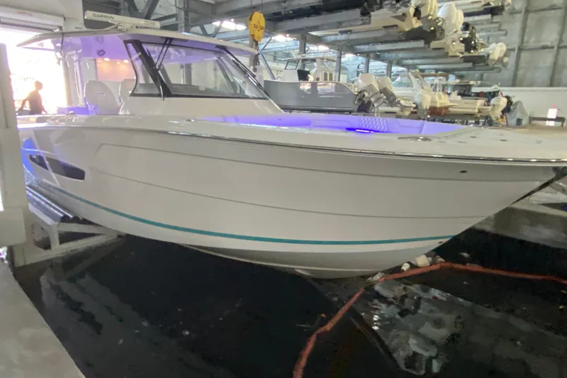 Slide: The Image of 2021 Regal 38 SAV boat in a marina, illuminated with blue lights. - 6