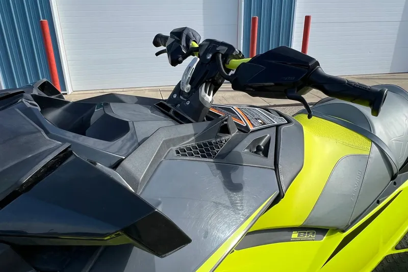 Slide: The Image of 2018 Sea-Doo RXP-X 300 jet ski, vibrant yellow and black design, parked outdoors. - 12