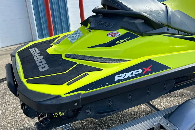 Slide: The Image of 2018 Sea-Doo RXP-X 300 jet ski, vibrant yellow, on a trailer. - 5