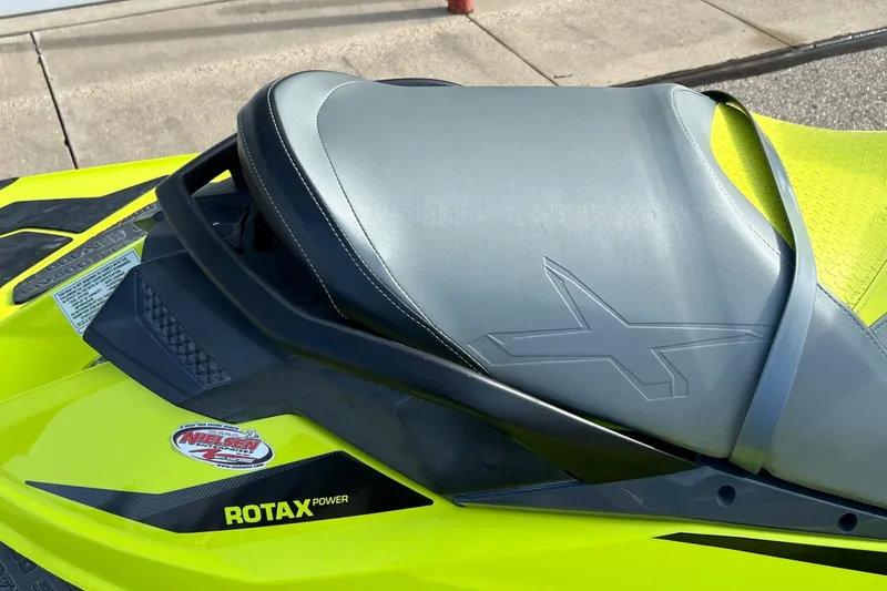 Slide: The Image of 2018 Sea-Doo RXP-X 300 jet ski seat with Rotax power branding, vibrant yellow design. - 6