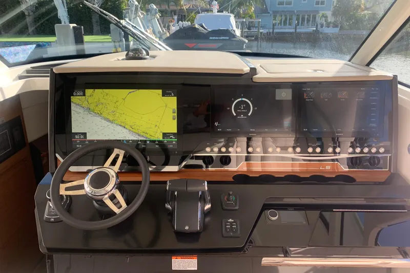 Slide: The Image of Helm of 2022 Tiara Yachts 48 LS with advanced navigation displays and controls. - 11