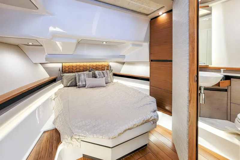 Slide: The Image of Luxurious cabin interior of 2022 Tiara Yachts 48 LS with modern design and cozy bedding. - 26