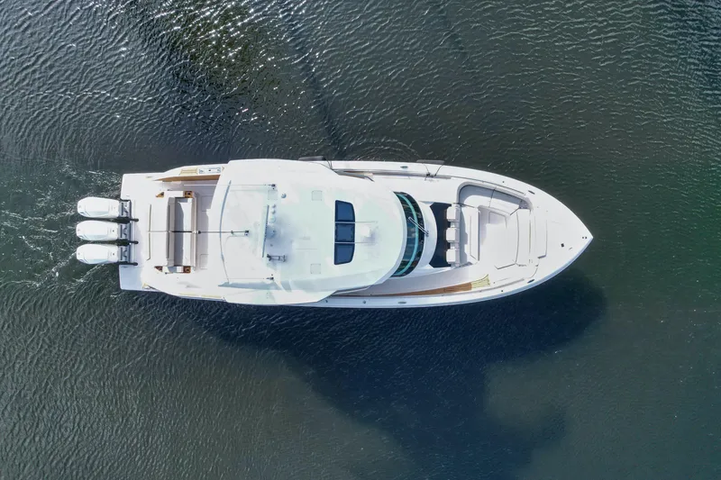 Slide: The Image of Aerial view of 2022 Tiara Yachts 48 LS cruising on water. - 6