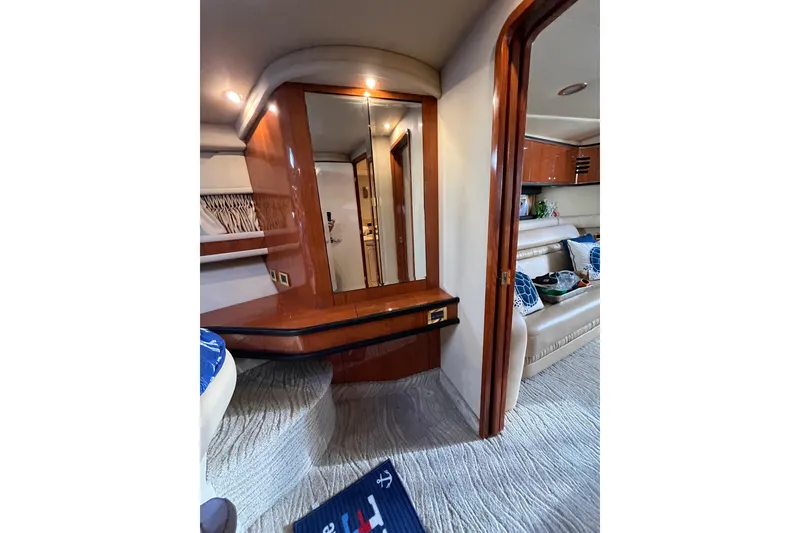 Slide: The Image of Interior of 2000 Sea Ray 460 Sundancer yacht with elegant wood finish and cozy seating. - 10