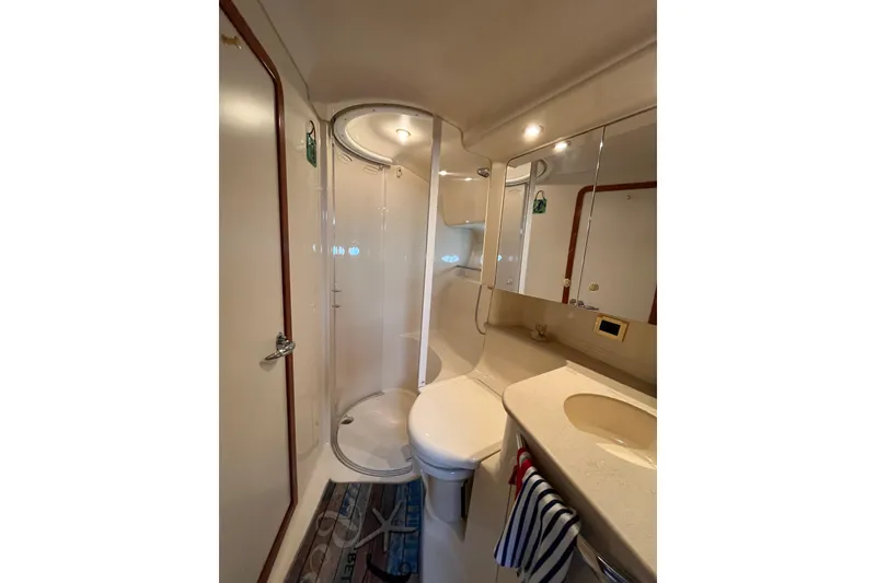 Slide: The Image of Bathroom interior of 2000 Sea Ray 460 Sundancer yacht, featuring shower and sink. - 13