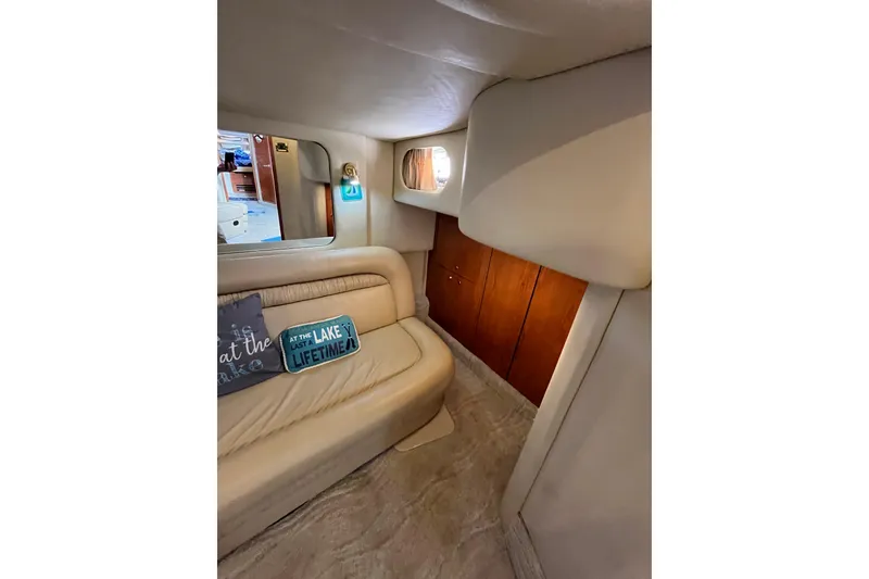 Slide: The Image of Interior of 2000 Sea Ray 460 Sundancer with beige seating and decorative pillows. - 16
