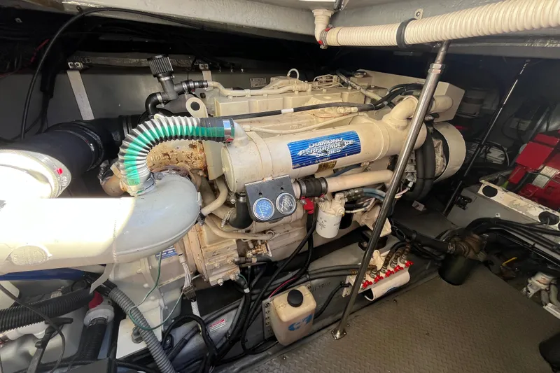 Slide: The Image of Engine room of 2000 Sea Ray 460 Sundancer, showcasing detailed mechanical components. - 19