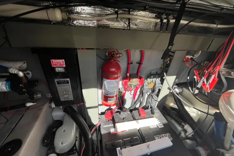 Slide: The Image of Engine compartment of a 2000 Sea Ray 460 Sundancer with fire extinguisher and battery setup. - 20