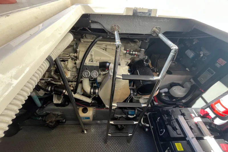 Slide: The Image of Engine room of a 2000 Sea Ray 460 Sundancer with visible components and ladder. - 21