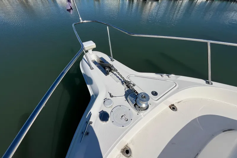 Slide: The Image of Bow of 2000 Sea Ray 460 Sundancer yacht with anchor and railing in calm water. - 4