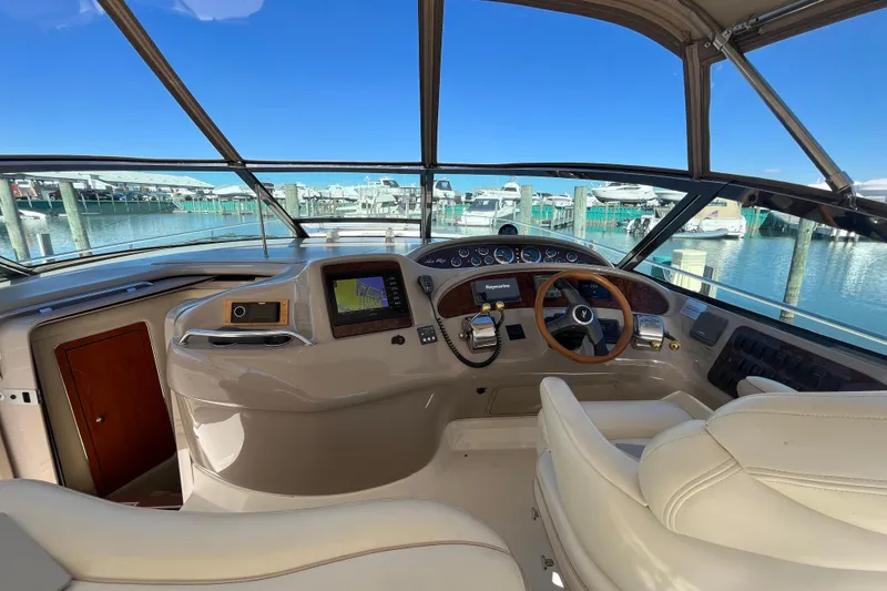 Slide: The Image of Cockpit of 2000 Sea Ray 460 Sundancer yacht with marina view. - 6