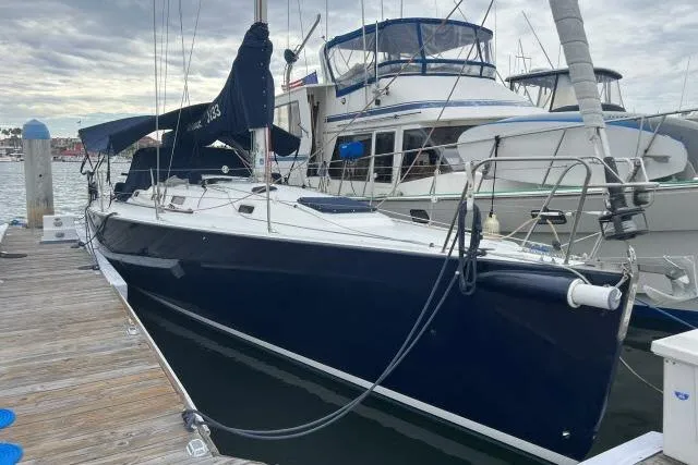 The Image of 2004 J Boats J/133 sailboat docked at marina, featuring sleek design and dark hull. - 0