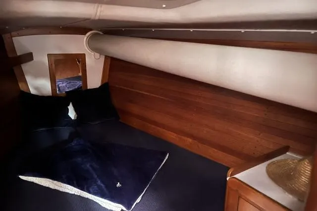 Slide: The Image of Cozy cabin interior of 2004 J Boats J/133 with wooden paneling and bedding. - 14