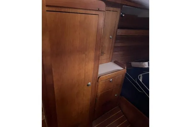Slide: The Image of Interior of 2004 J Boats J/133, featuring wooden cabinetry and sleek design elements. - 16