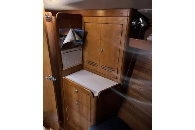 Slide: The Image of 2004 J Boats J/133 interior with wooden cabinetry and foldable table. - 17