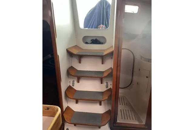 Slide: The Image of Interior stairs of 2004 J Boats J/133 sailboat with wooden steps. - 19