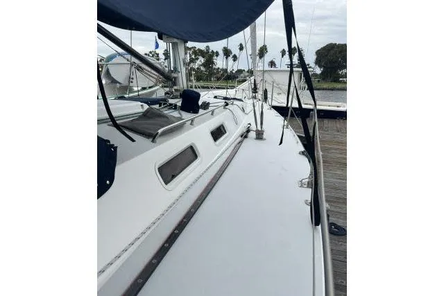 Slide: The Image of 2004 J Boats J/133 sailboat deck view at marina, showcasing sleek design and rigging. - 32