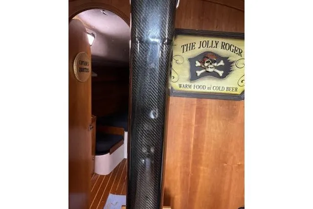 Slide: The Image of Interior of 2004 J Boats J/133 with pirate-themed decor and wooden finish. - 4