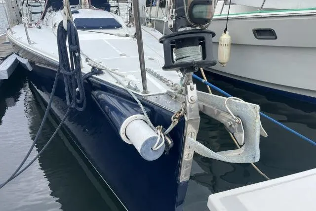 Slide: The Image of 2004 J Boats J/133 sailboat docked, featuring anchor and deck details. - 44