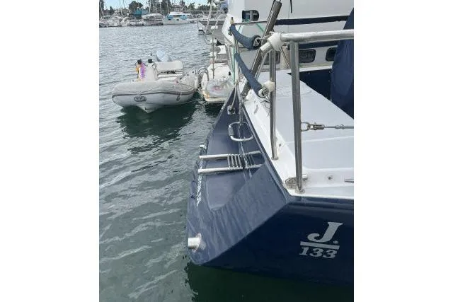 Slide: The Image of 2004 J Boats J/133 yacht docked with inflatable dinghy nearby. - 46