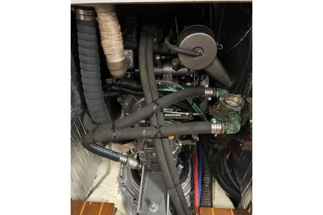 Slide: The Image of Engine compartment of a 2004 J Boats J/133 sailboat, showing hoses and mechanical components. - 47