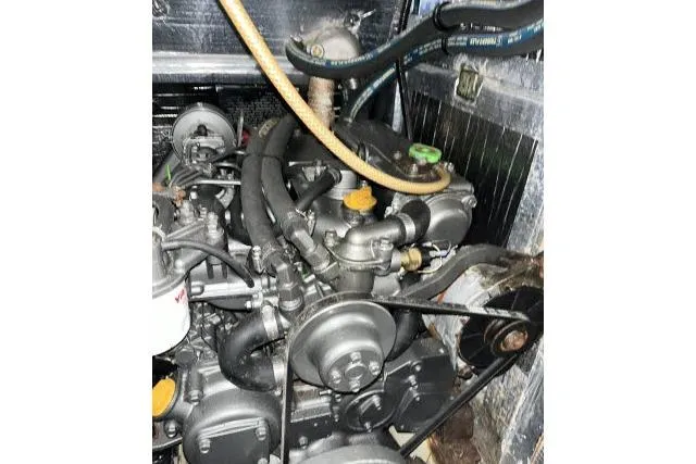 Slide: The Image of Engine of a 2004 J Boats J/133 sailboat, showcasing mechanical components and hoses. - 49