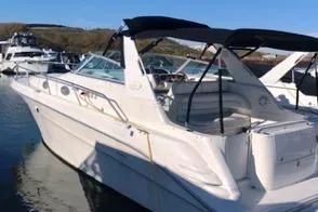 Slide: The Image of 1996 Sea Ray 330 Sundancer boat docked in a marina under clear blue skies. - 3