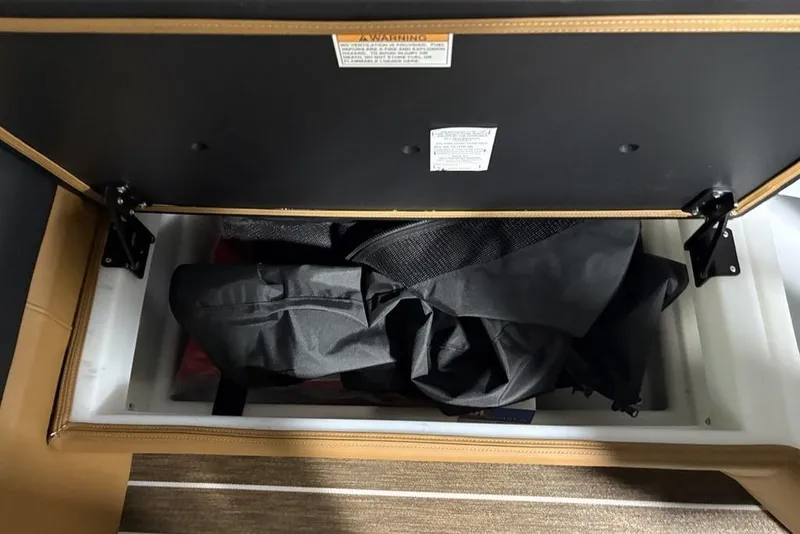 Slide: The Image of Storage compartment in 2026 Premier 230 Sunsation RL boat, containing black fabric. - 10