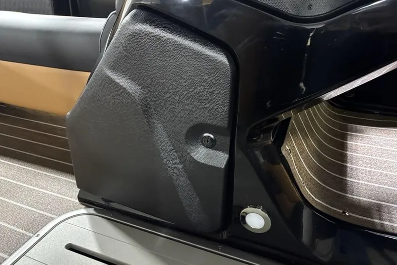 Slide: The Image of Interior detail of 2026 Premier 230 Sunsation RL boat, featuring sleek black paneling. - 14