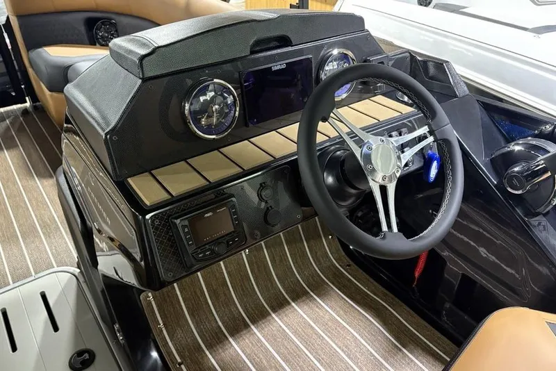 Slide: The Image of 2026 Premier 230 Sunsation RL boat dashboard with steering wheel and modern controls. - 18